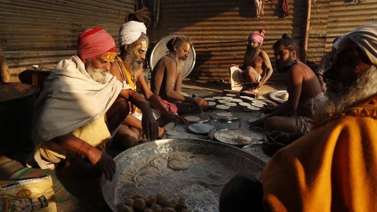 Holy men prepare food on the banks of the river Ganges during Magh Mela festival, in Prayagraj, India, Tuesday, Feb. 16, 2021.(AP)