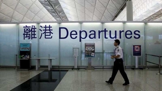 FILE PHOTO: An airport security guard walks past a sign at the departure hall of Hong Kong Airport June 23, 2013. REUTERS/Bobby Yip(REUTERS)