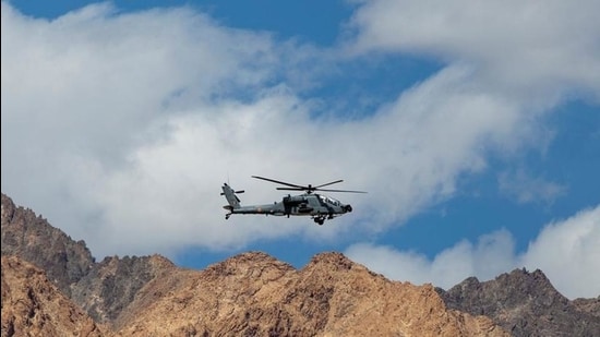 An Indian Air Force Apache helicopter flies over the Ladakh region. (REUTERS)