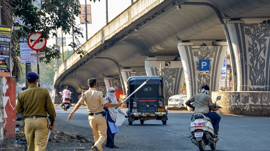 Amravati: Police stop commuters after a restriction was imposed due to an increase in COVID-19 cases, in Amravati, Maharashtra, Wednesday, Feb 24, 2021. (PTI Photo) (PTI02_24_2021_000194B)(PTI) Amravati: Police stop commuters after a restriction was imposed due to an increase in COVID-19 cases, in Amravati, Maharashtra, Wednesday, Feb 24, 2021. (PTI Photo) (PTI02_24_2021_000194B)(PTI)
