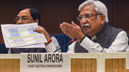 Chief Election Commissioner Sunil Arora shows a document during a press conference in New Delhi on Friday, (PTI PHOTO) Chief Election Commissioner Sunil Arora shows a document during a press conference in New Delhi on Friday, (PTI PHOTO)