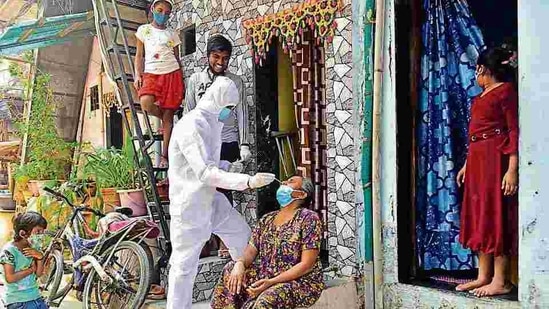 A BMC medical staffer collects the swab sample of a resident at Dharavi on Tuesday. (Anshuman Poyrekar/HT Photo) A BMC medical staffer collects the swab sample of a resident at Dharavi on Tuesday. (Anshuman Poyrekar/HT Photo)