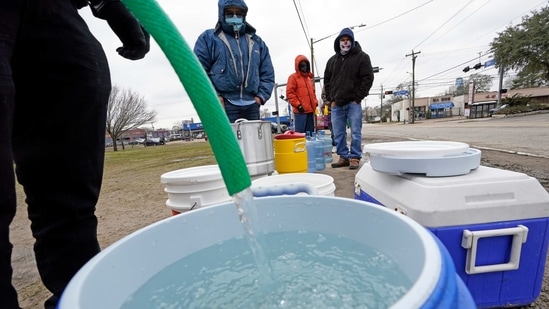 FILE - In this Feb. 18, 2021, file photo, a water bucket is filled as others wait in near freezing temperatures to use a hose from public park spigot in Houston. The snow and ice that crippled some states across the South has melted. But it has exposed the fragility of aging waterworks that experts have been warning about for years. Cities across Texas, Tennessee, Louisiana and Mississippi are still grappling with outages that crippled health care facilities and forced families to wait in line for potable water. (AP Photo/David J. Phillip, File)(AP) FILE - In this Feb. 18, 2021, file photo, a water bucket is filled as others wait in near freezing temperatures to use a hose from public park spigot in Houston. The snow and ice that crippled some states across the South has melted. But it has exposed the fragility of aging waterworks that experts have been warning about for years. Cities across Texas, Tennessee, Louisiana and Mississippi are still grappling with outages that crippled health care facilities and forced families to wait in line for potable water. (AP Photo/David J. Phillip, File)(AP)