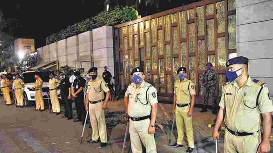 Police personnel stand guard outside Mukesh Ambani's residence Antilla after explosives were found in an abandoned car in its vicinity, in Mumbai, on Thursday. (Bhushan Koyande / Hindustan Times)