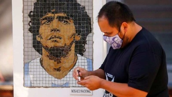 The mosaics, made up of small tiles to ensure they are durable and easy to fix in case of vandalism, show Maradona in a jersey of one of the teams he played for, looking at the horizon.(Reuters)