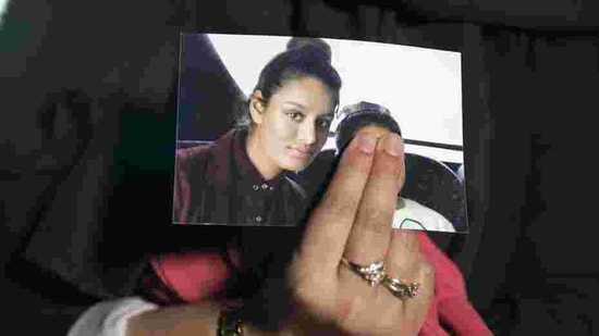 In this file photo taken on February 22, 2015, Renu Begum, eldest sister of missing British girl Shamima Begum, holds a picture of her sister while being interviewed by the media in central London.(AFP)