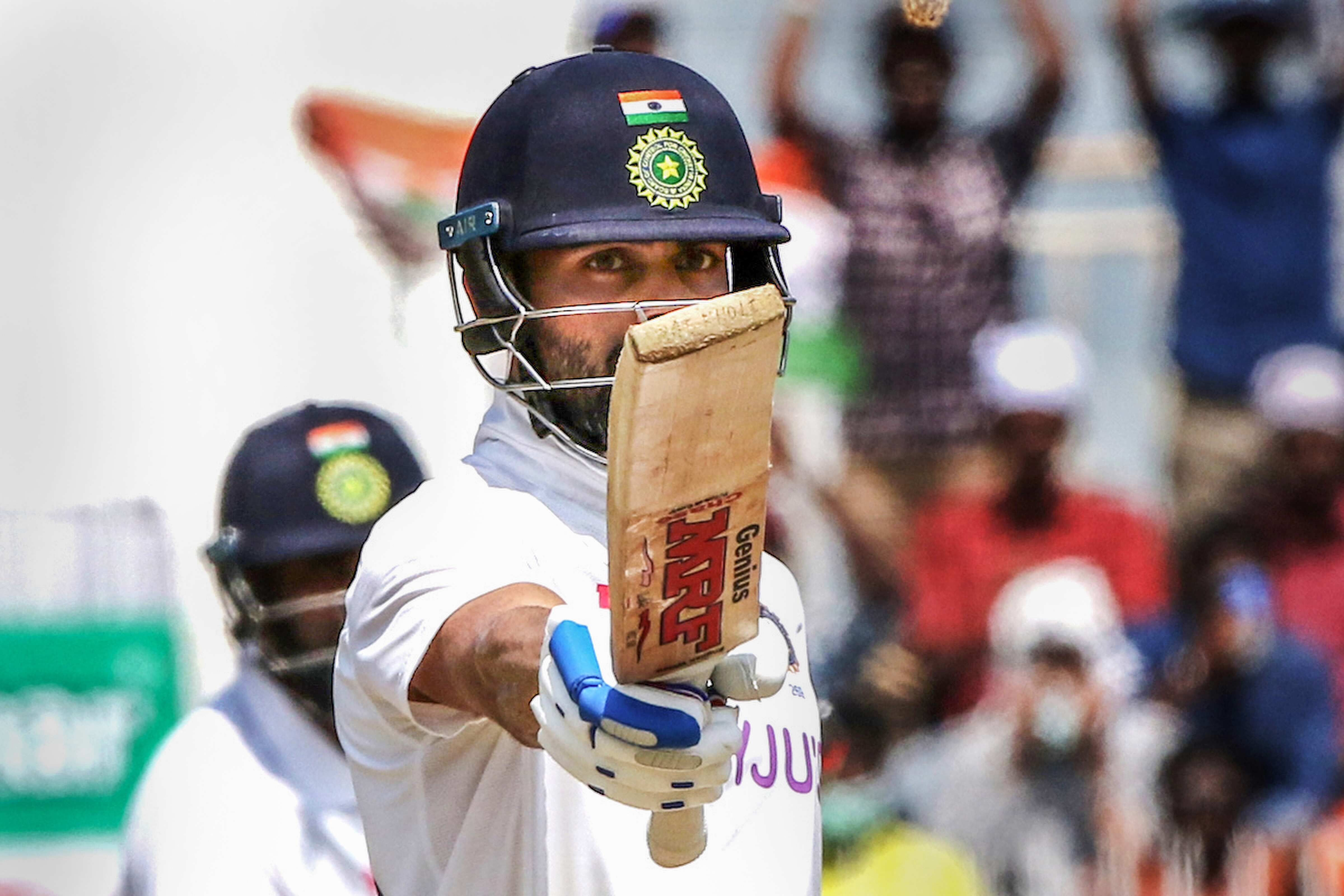 Indian Captain Virat Kohli raises his bat after scoring a half-century during the 3rd day of second cricket test match between India and England, at M.A. Chidambaram Stadium. (PTI) Indian Captain Virat Kohli raises his bat after scoring a half-century during the 3rd day of second cricket test match between India and England, at M.A. Chidambaram Stadium. (PTI)