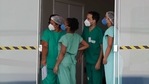 Health workers wait for a discharged Covid-19 patient before his departure from the Luziania field hospital, a suburb of Brasilia, Brazil, (AP) Health workers wait for a discharged Covid-19 patient before his departure from the Luziania field hospital, a suburb of Brasilia, Brazil, (AP)