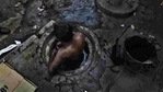Municipal worker attempts to unblock a sewer overflowing with human excreta in New Delhi. Although a law bans manual scavenging - the manual removal of human excreta from 'dry toilets' - the practice is widespread across cities and towns in India.(Photo: Raj K Raj / Hindustan Times) Municipal worker attempts to unblock a sewer overflowing with human excreta in New Delhi. Although a law bans manual scavenging - the manual removal of human excreta from 'dry toilets' - the practice is widespread across cities and towns in India.(Photo: Raj K Raj / Hindustan Times)