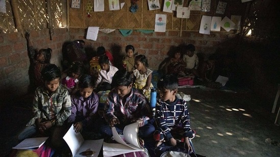 Imradul Ali, 10, second from left, studies with other students at a school near a landfill on the outskirts of Guwahati, India, Thursday, Feb. 4, 2021. (AP)
