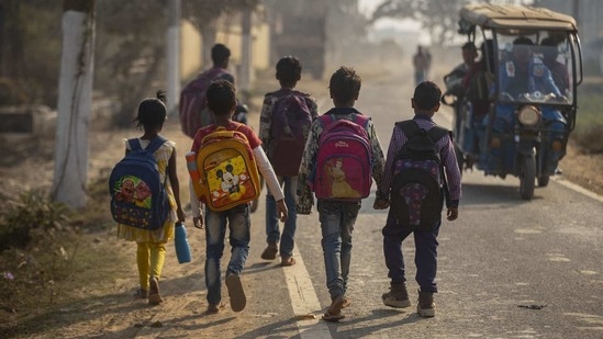 Imradul Ali, 10, right, and his friends go to a school near a landfill on the outskirts of Guwahati, India, Thursday, Feb. 4, 2021. (AP)