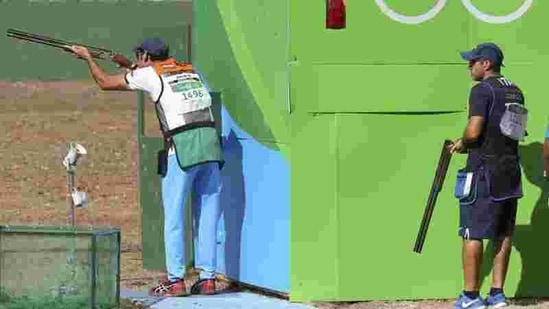 Mairaj Ahmad Khan (IND) of India competes as Luigi Lodde (ITA) of Italy watches. Khan failed to qualify for the skeet final. ((REUTERS)) Mairaj Ahmad Khan (IND) of India competes as Luigi Lodde (ITA) of Italy watches. Khan failed to qualify for the skeet final. ((REUTERS))