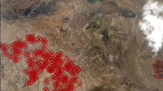 Satellite image of Gijet in Tigray region with marked red crosses relate to number of structures significantly damaged and orange crosses show limited damage, lines to the right identify visible scorching.(via REUTERS)