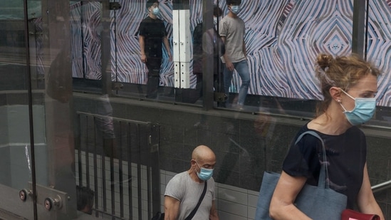 FILE PHOTO: Commuters wearing protective face masks in accordance with new public health regulations for riding public transit depart a train station in the wake of a coronavirus disease (COVID-19) outbreak in Sydney, Australia, January 6, 2021.  REUTERS/Loren Elliott/File Photo (REUTERS)
