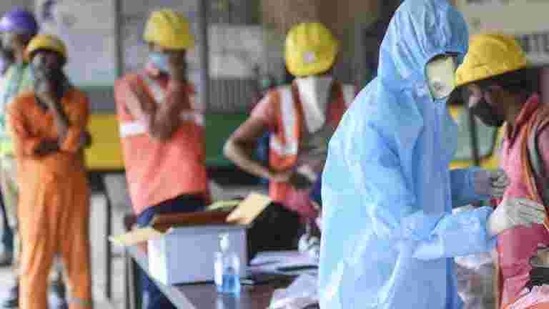 A BMC health worker collects swab sample of a construction worker for Covid-19 test in Mumbai on February 25. (PTI) A BMC health worker collects swab sample of a construction worker for Covid-19 test in Mumbai on February 25. (PTI)