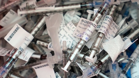 Used Covid-19 vaccination syringes used to administer the Pfizer vaccine are shown in a container.(AP) Used Covid-19 vaccination syringes used to administer the Pfizer vaccine are shown in a container.(AP)