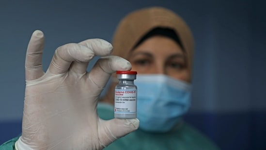 A Palestinian health worker holds a vial of Covid-19 vaccine at the Palestine Red Crescent hospital in the West Bank city of Nablus, on February 4, 2021. (AFP)