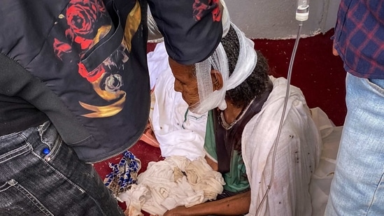 In this Monday, Nov. 30, 2020 file photo, an elderly woman who fled from the town of Shire to the city of Axum to seek safety, but was then wounded in the jaw during an attack on the city, sits with her head bandaged before dying of her injuries days later, in Axum, in the Tigray region of Ethiopia.(AP Photo) In this Monday, Nov. 30, 2020 file photo, an elderly woman who fled from the town of Shire to the city of Axum to seek safety, but was then wounded in the jaw during an attack on the city, sits with her head bandaged before dying of her injuries days later, in Axum, in the Tigray region of Ethiopia.(AP Photo)