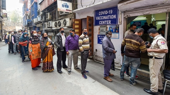 Frontline workers stand in a queue to receive their first dose of Covaxin in New Delhi.(PTI)