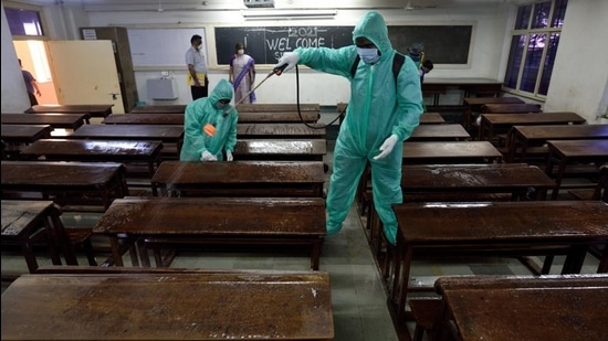 A worker sanitises a classroom at a college in Mumbai. (HT FILE) A worker sanitises a classroom at a college in Mumbai. (HT FILE)