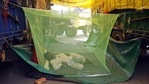 A farmer sleeps inside a mosquito net during a protest against the new farm laws, at the Singhu border in New Delhi on Sunday. (ANI Photo) A farmer sleeps inside a mosquito net during a protest against the new farm laws, at the Singhu border in New Delhi on Sunday. (ANI Photo)