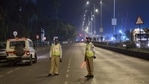 Police officers maintain vigil at Marine Drive during the night curfew in Mumbai.(PTI) Police officers maintain vigil at Marine Drive during the night curfew in Mumbai.(PTI)