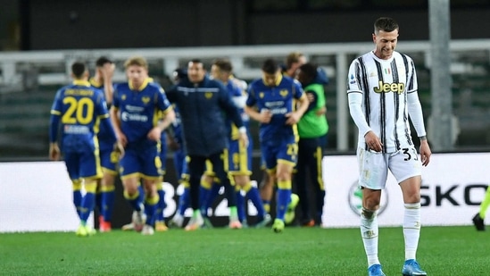 Juventus' Federico Bernardeschi looks dejected as Hellas Verona's Antonin Barak celebrates scoring their first goal with teammates.(REUTERS)