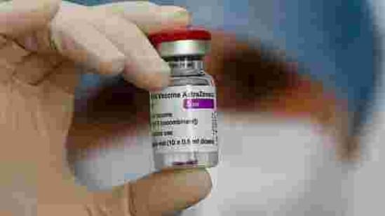 A health worker holds up a dose of the AstraZeneca vaccine against Covid-19.(AP)