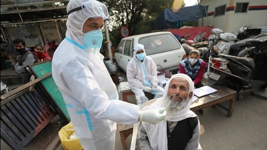 A health worker collects a nasal sample from a man for Covid-19 test in Jammu (PTI) A health worker collects a nasal sample from a man for Covid-19 test in Jammu (PTI)