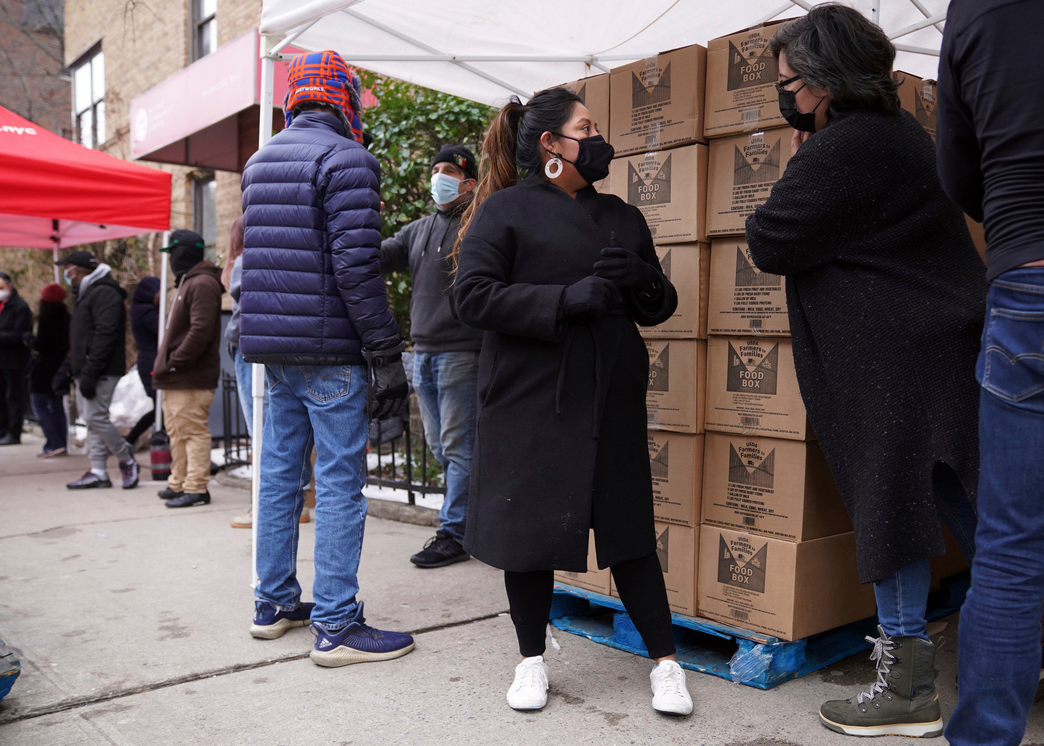 Volunteer Gloria Martinez, left, speaks with Sofia Moncayo, who runs a food distribution program.(AP) Volunteer Gloria Martinez, left, speaks with Sofia Moncayo, who runs a food distribution program.(AP)