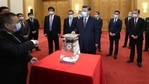 Chinese President Xi Jinping, center, and other Chinese leaders look at a display of lunar samples retrieved from the moon by China's Chang'e 5 lunar lander at the Great Hall of the People in Beijing. (AP) Chinese President Xi Jinping, center, and other Chinese leaders look at a display of lunar samples retrieved from the moon by China's Chang'e 5 lunar lander at the Great Hall of the People in Beijing. (AP)