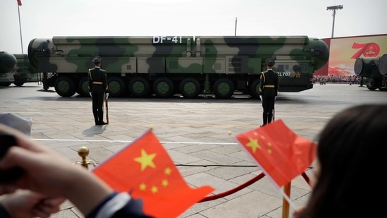 Trucks carrying weapons including a nuclear-armed missile designed to evade US defenses roll during a parade to commemorate the 70th anniversary of the founding of Communist China in Beijing in this file photo from 2019. (AP Photo) Trucks carrying weapons including a nuclear-armed missile designed to evade US defenses roll during a parade to commemorate the 70th anniversary of the founding of Communist China in Beijing in this file photo from 2019. (AP Photo)