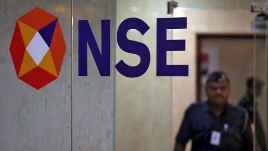 A security guard walks past the logo of the National Stock Exchange (NSE) building in Mumbai. (REUTERS) A security guard walks past the logo of the National Stock Exchange (NSE) building in Mumbai. (REUTERS)