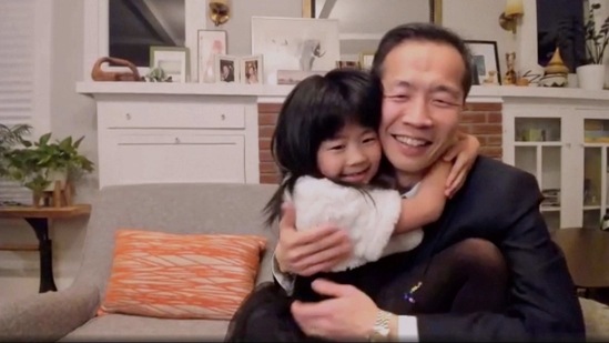 Director Lee Isaac Chung is hugged by his daughter as he accepts the award for best foreign language motion picture for "Minari" from the United States at the Golden Globe Awards.(NBC via AP)