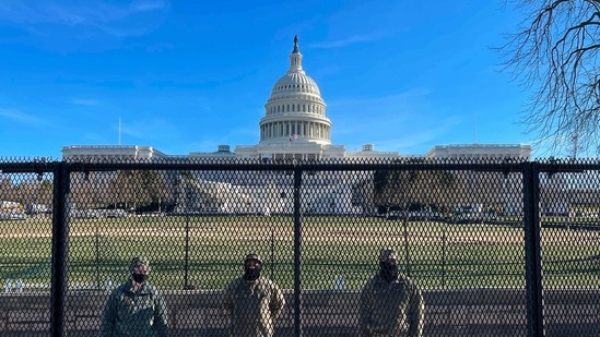 US National Guard soldiers guard the grounds of the US Capitol from behind a security fence in Washington, DC, on January 9, 2021. - US Democrats on January 9 were readying for an unprecedented second impeachment of Donald Trump as the defiant US President showed no signs of stepping down after the deadly violence at the Capitol on January 6. (Photo by Daniel SLIM / AFP)(AFP)