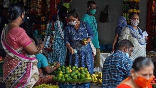 A woman wearing a protective face mask buys fruit in a market, amidst the spread of the coronavirus disease (Covid-19) in Mumbai,. (Reuters Photo) A woman wearing a protective face mask buys fruit in a market, amidst the spread of the coronavirus disease (Covid-19) in Mumbai,. (Reuters Photo)