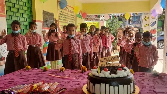 Children were greeted With cake, laddu, balloons and flowers on day one of reopening of government primary schools in Lucknow. Photo by Deepak Gupta/HT(Deepak Gupta/HT)