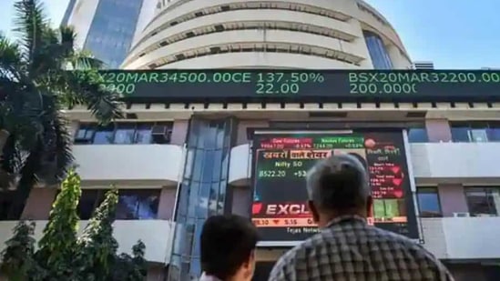 People watch the Sensex on a screen outside Bombay Stock Exchange (BSE) in Mumbai. (PTI File Photo ) People watch the Sensex on a screen outside Bombay Stock Exchange (BSE) in Mumbai. (PTI File Photo )