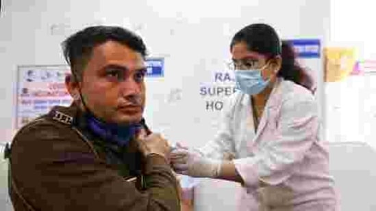 A health worker administers Covid-19 vaccine to a Delhi Police personnel at a hospital in New Delhi.(AP) A health worker administers Covid-19 vaccine to a Delhi Police personnel at a hospital in New Delhi.(AP)