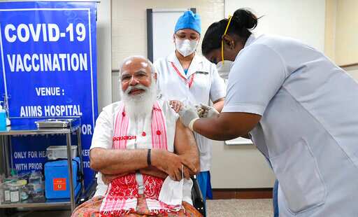 At the time of vaccination, PM Modi was seen sporting a traditional gamosa. (PMO) At the time of vaccination, PM Modi was seen sporting a traditional gamosa. (PMO)