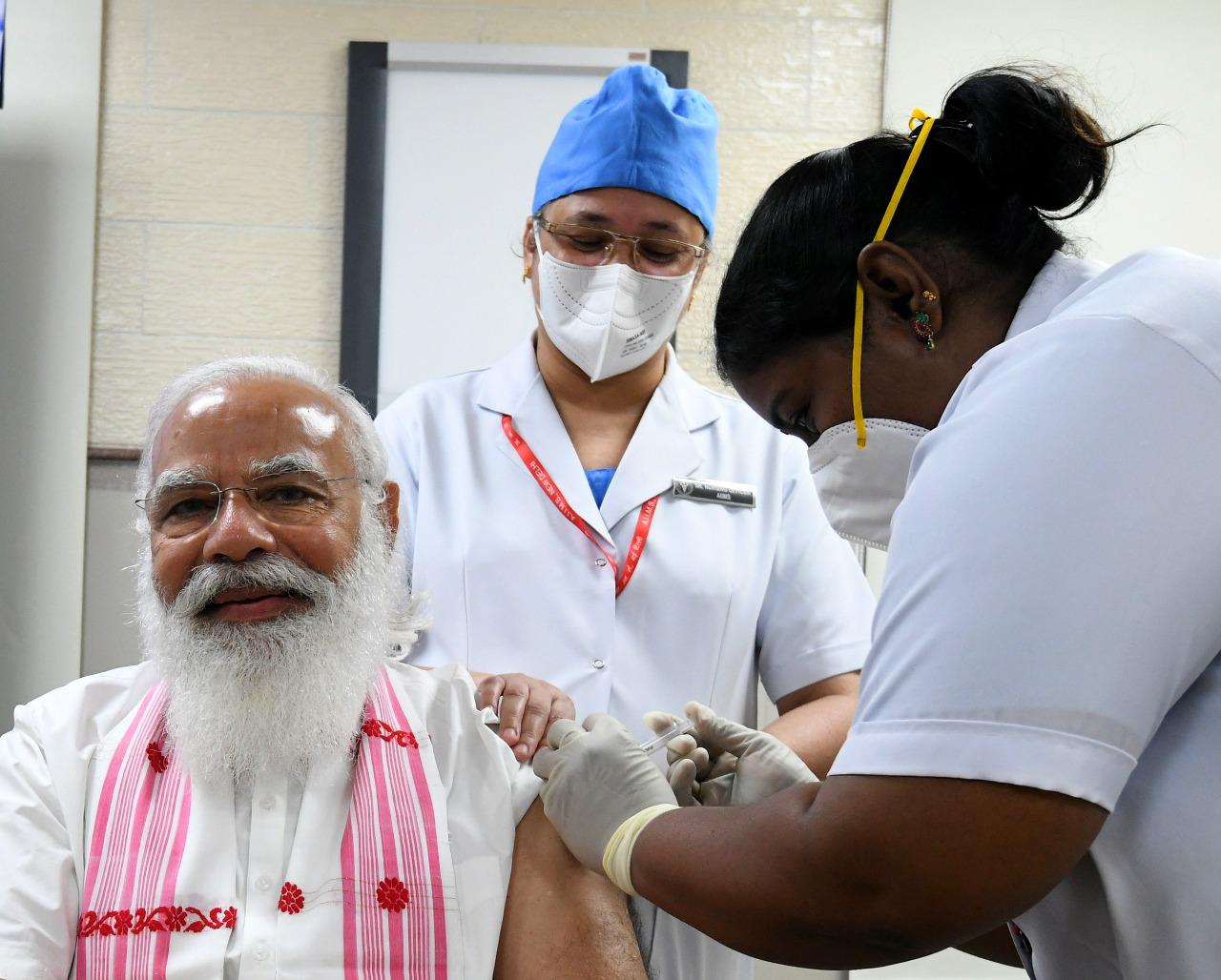PM Modi with two healthcare workers takes his first jab of Covid-19 vaccine. PM Modi with two healthcare workers takes his first jab of Covid-19 vaccine.