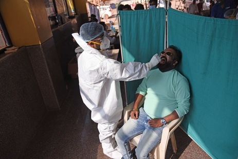A medic in PPE takes a swab sample for during RT-PCR based coronavirus testing at NMMC Hospital Nerul in Navi Mumbai, Maharashtra. (Bachchan Kumar/ Hindustan Times)