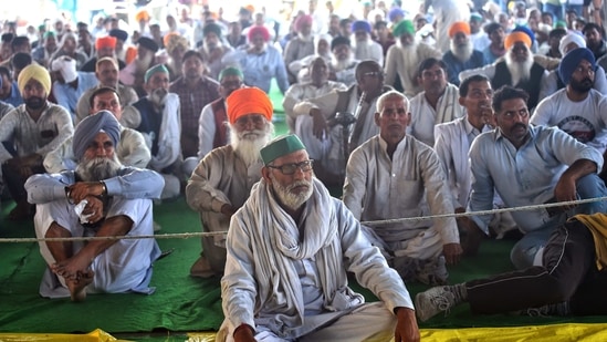 Farmers sitting at the demonstration site during the ongoing farmer protest against the new farm laws at Ghazipur Border, in New Delhi. (ANI Photo)