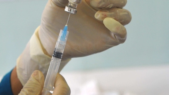 A health worker draws a syringe from a vaccine vial at Civil Hospital in Sector 45, Chandigarh on March 1. Amid the teething troubles and the crowds seen at the hospitals, there were close to 430,000 doses administered on March 1 – lower than the peak of roughly 800,000 seen late last month, HT reported.(Keshav Singh / HT Photo)