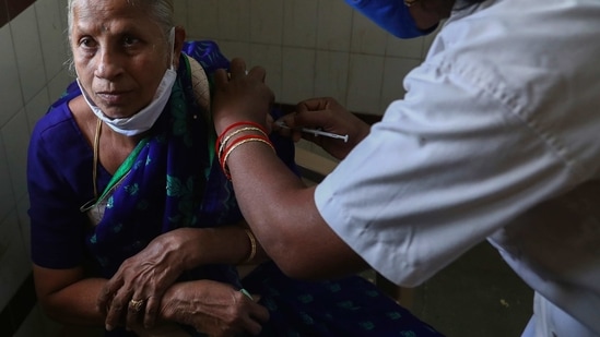 A health worker administers Covid-19 vaccine to an elderly woman at a government hospital in Siddipet, Telangana on March 1. Over the past three days, India has recorded over 16,000 cases on an average, compared to close to 12,000 in the middle of last month, HT reported.(Mahesh Kumar A / AP)
