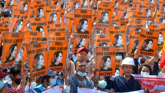 Protesters hold posters with the image of detained civilian leader Aung San Suu Kyi during a demonstration against the military coup in Naypyidaw.(AFP)