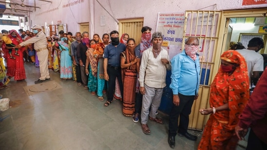 Voters stand in a queue to cast their vote at a polling centre in the first phase of Gujarat civic body elections.(PTI) Voters stand in a queue to cast their vote at a polling centre in the first phase of Gujarat civic body elections.(PTI)