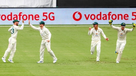 Australia's Matthew Wade, left, is congratulated by teammate Steve Smith on a catch to dismiss India's Ajinkya Rahane as David Warner and Tim Paine react during play on day three of the fourth cricket test between India and Australia at the Gabba, Brisbane, Australia.(AP)