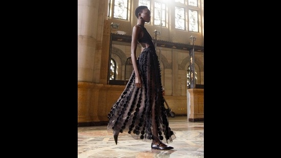 A model sports a black sheer panelled dress with cutout details on the sides (Photo: Instagram/CarolinaHerrera) A model sports a black sheer panelled dress with cutout details on the sides (Photo: Instagram/CarolinaHerrera)
