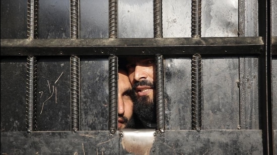 A file photo of Taliban prisoners looking through the door of a prison after an attack in the city of Jalalabad in Afghanistan. (AP) A file photo of Taliban prisoners looking through the door of a prison after an attack in the city of Jalalabad in Afghanistan. (AP)